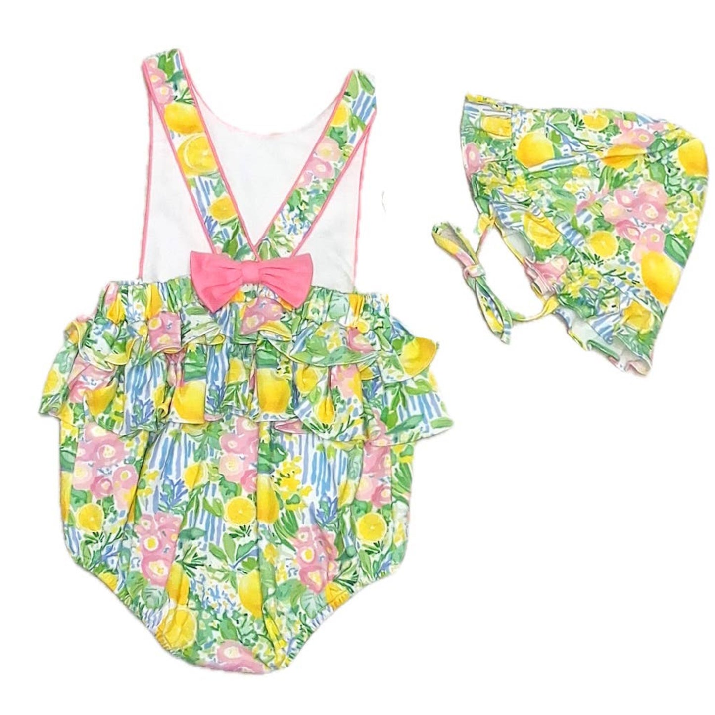 Children's swimsuit with lemon and floral pattern and matching hat on a white background