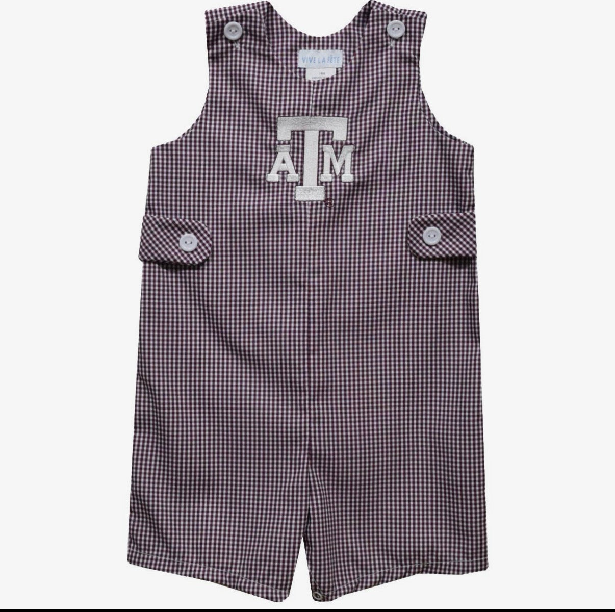 A sleeveless baby romper in a small gingham check pattern of dark purple and white, featuring a large white 'A&M' logo on the chest, buttoned shoulder straps, and side flap pockets.