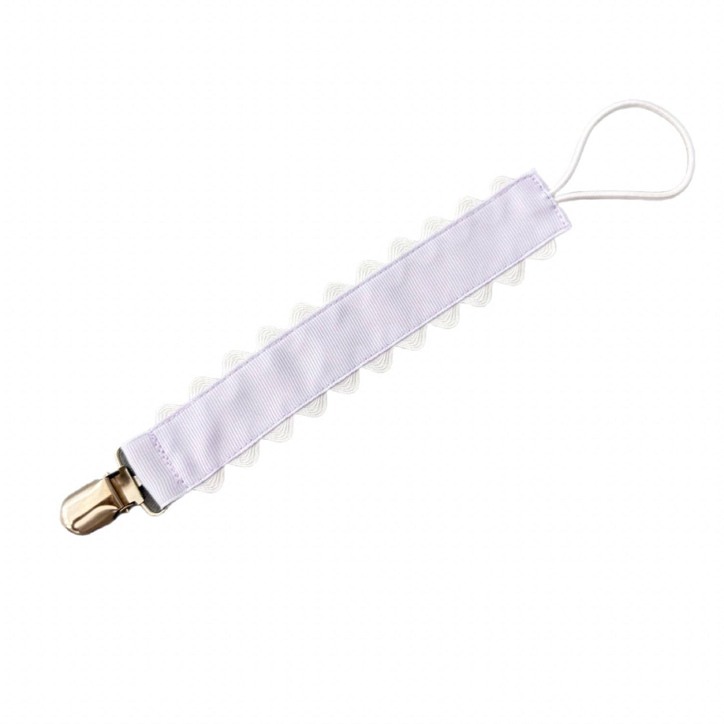 White pacifier clip with gold clip on a white background