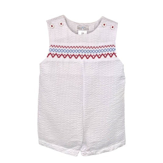 White baby romper with red and blue smocking on a white background