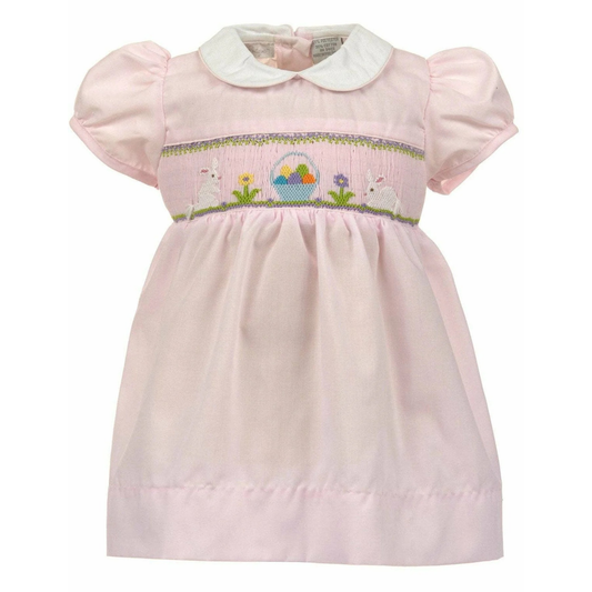 Pink dress with embroidered details on a white background