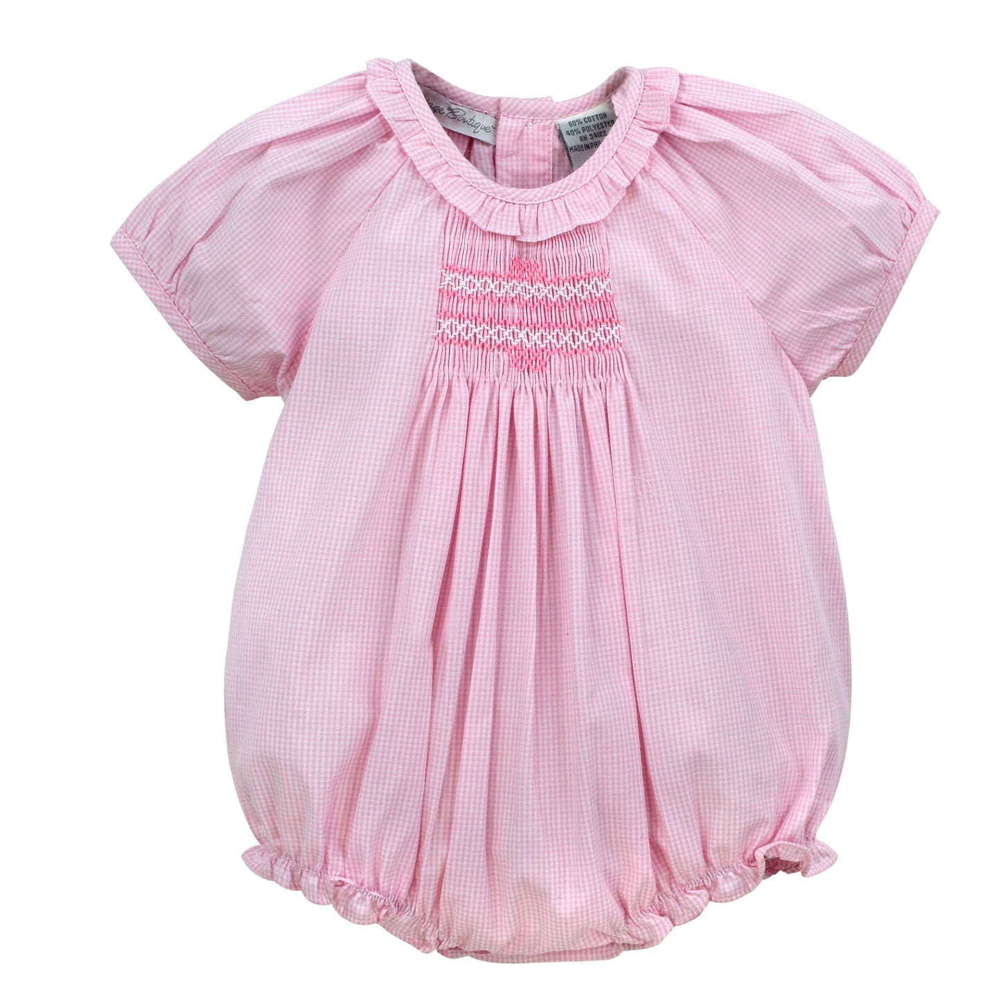 Pink baby romper with smocked details on a white background