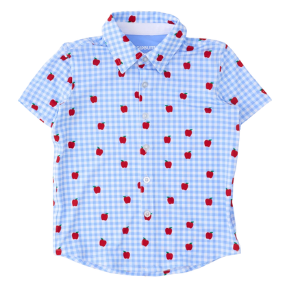 A short-sleeve button-up shirt for kids, featuring a light blue and white gingham check pattern with a scattered red apple print. The shirt has a classic collar and white buttons.