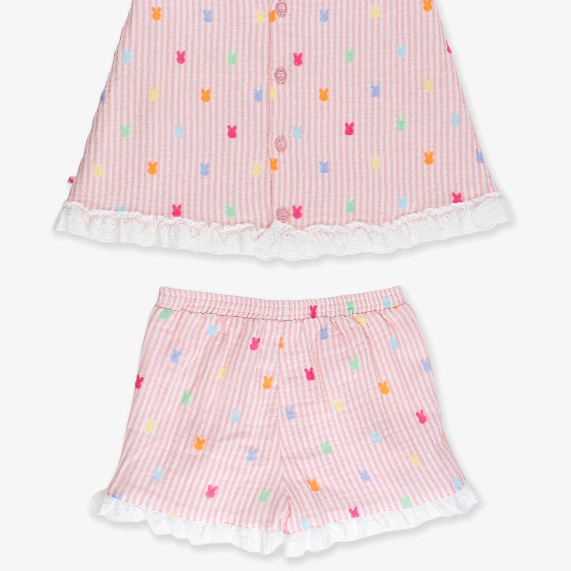 Pink children's outfit with colorful patterns on a white background