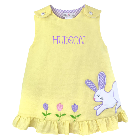 Yellow dress with bunny and flower design and 'Hudson' text on a white background