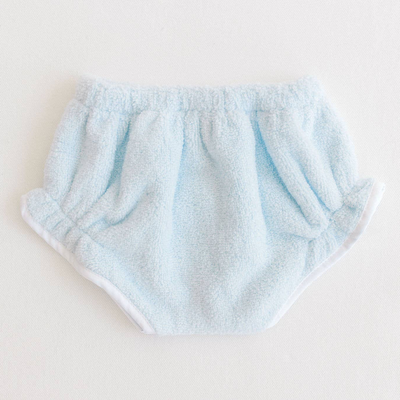 Light blue baby bloomers on a white background