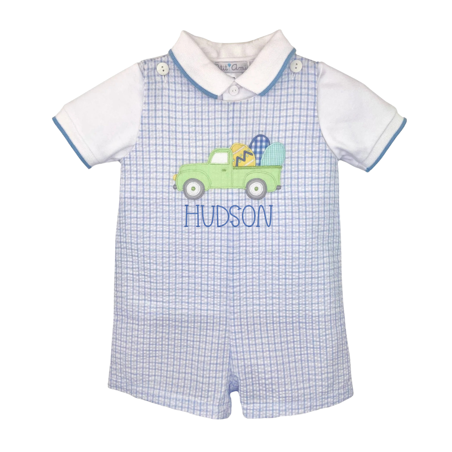 Baby romper with checkered pattern and embroidered truck design on a white background