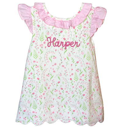 Floral dress with ruffled sleeves and 'Harper' printed on a white background