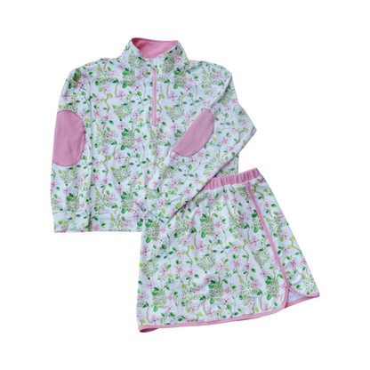 Children's floral outfit with pink accents on a white background