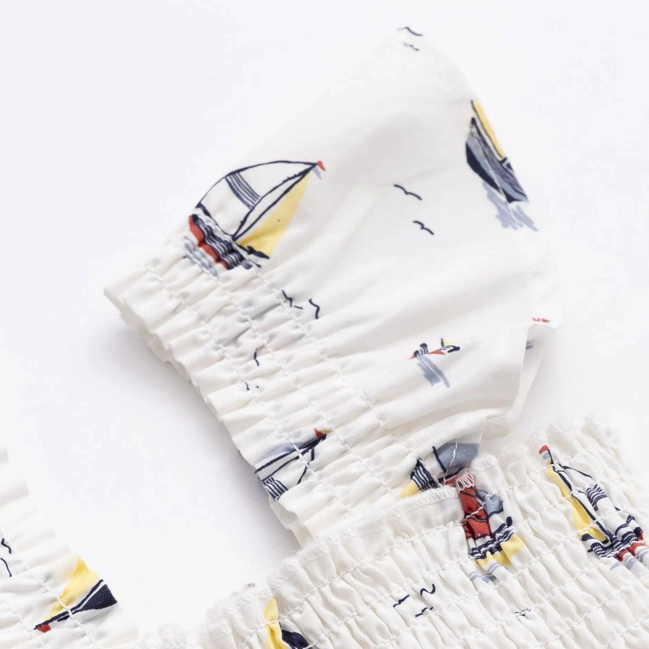 Girls flutter sleeve dress detail of flutter sleeve with sailboat pattern on a white background