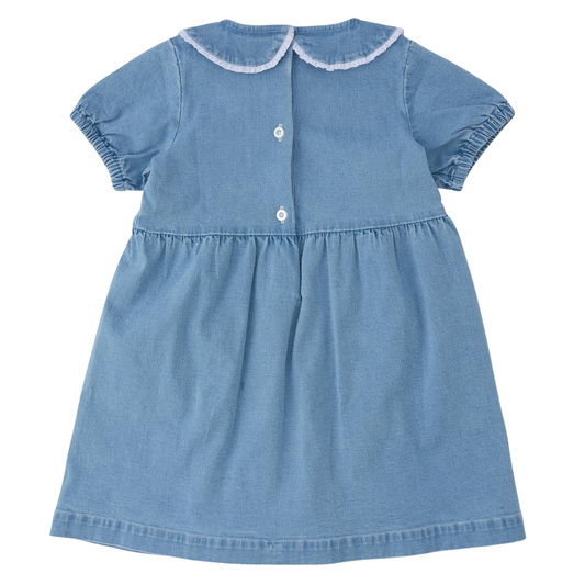 A light blue denim baby dress with short sleeves, a Peter Pan collar trimmed in white, and three white buttons on the front, shown against a plain white background.