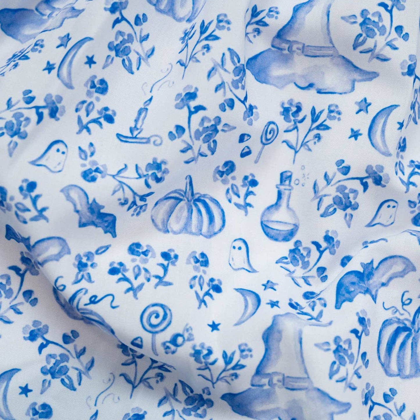 Blue floral and nature-themed pattern on white fabric