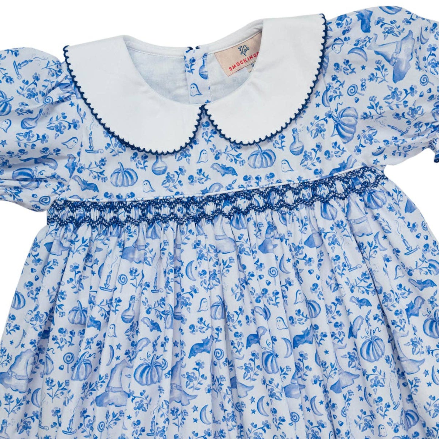 Children's dress with blue and white pattern on a white background