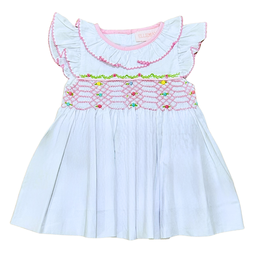 Light white dress with colorful embroidery on a white background