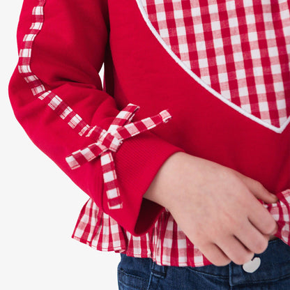 Red shirt with a large white heart design on a white background