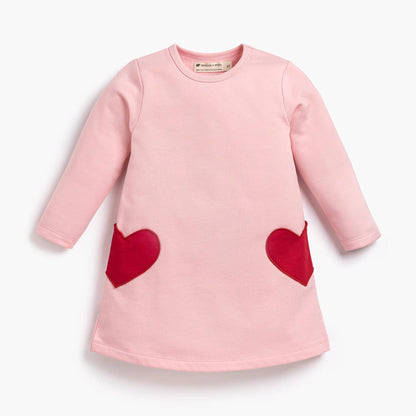 Pink dress with red heart patterns on a white background