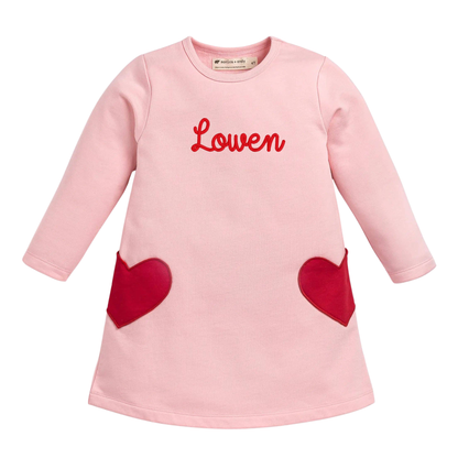 Pink dress with red hearts and 'Lowen' branding on a white background