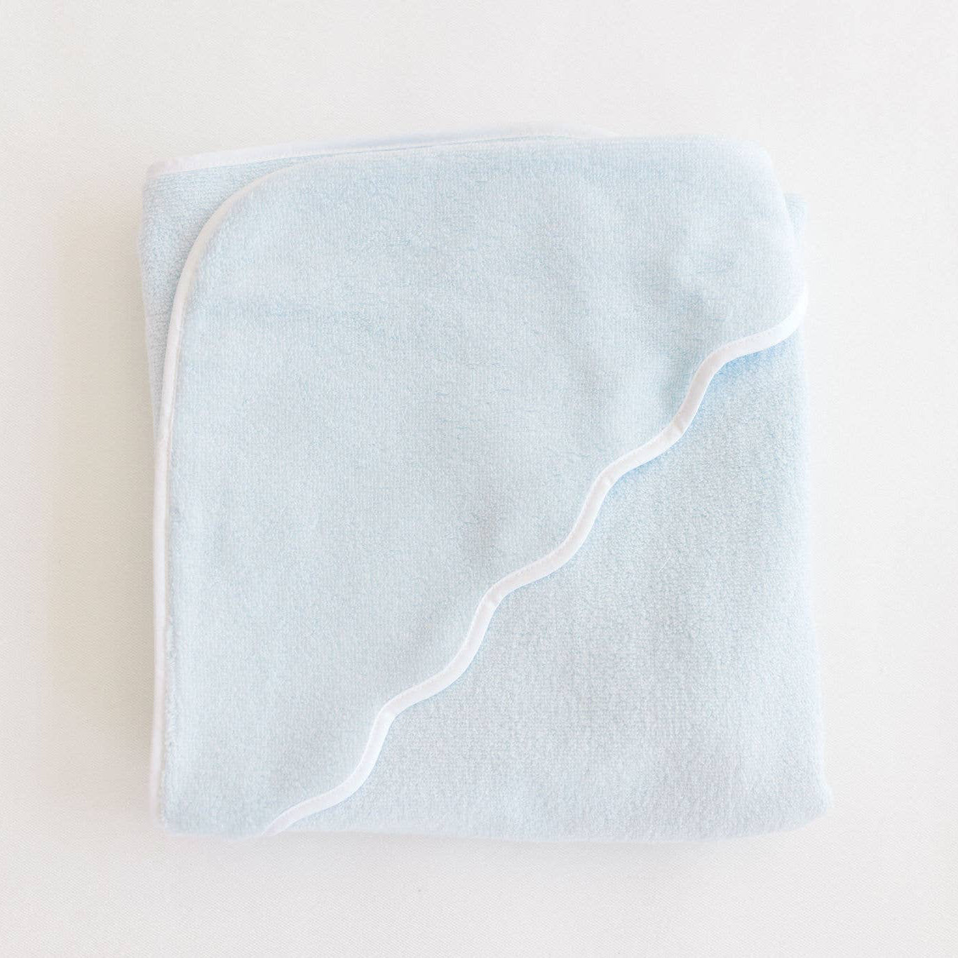 Light blue hooded baby towel on a white background