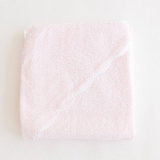 Pink Terrycloth Hooded Towel with white scallop edge on a light beige background