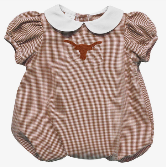 A toddler girl's short-sleeve bubble romper in a burnt orange and white gingham pattern, featuring a white Peter Pan collar and an embroidered orange Texas Longhorns logo on the chest.