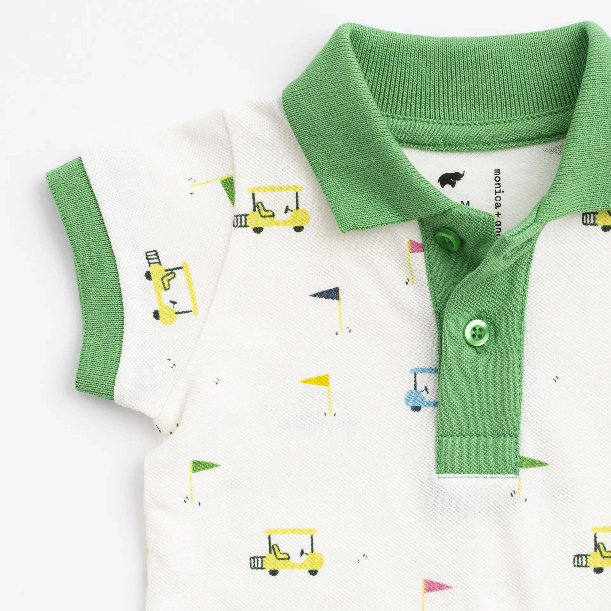 Green and white polo shirt romper with golf cart prints on a white background