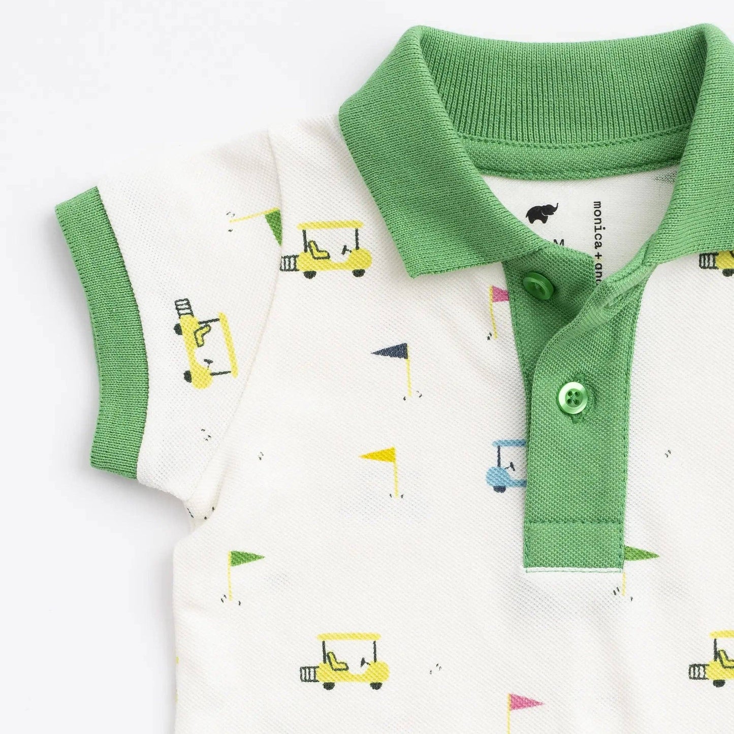 Green and white polo shirt with golf cart prints on a white background