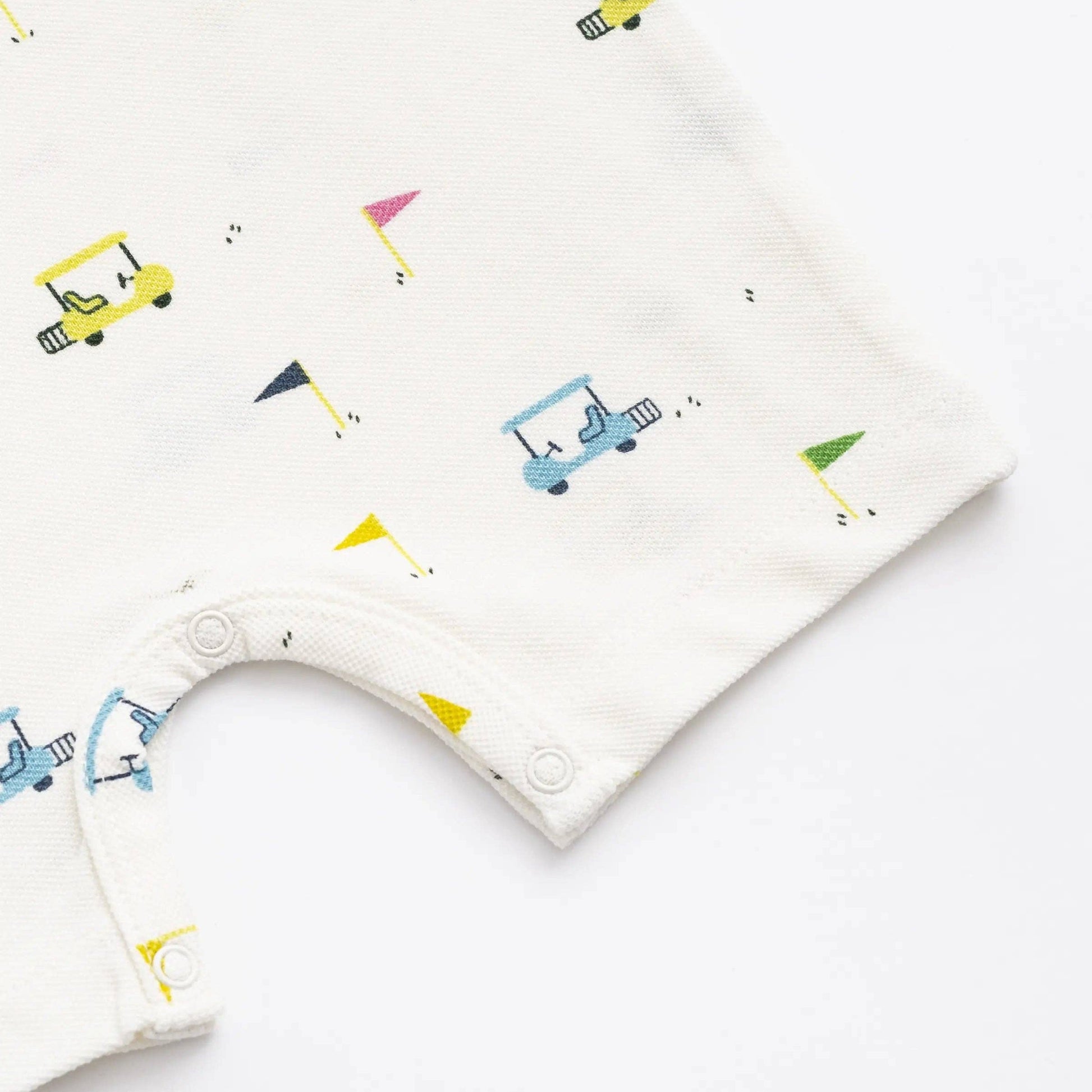Baby bib with colorful golf cart and flag pattern on a white background