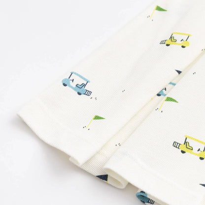 White dress with colorful golf carts on a white background detail of the skirt of the dress