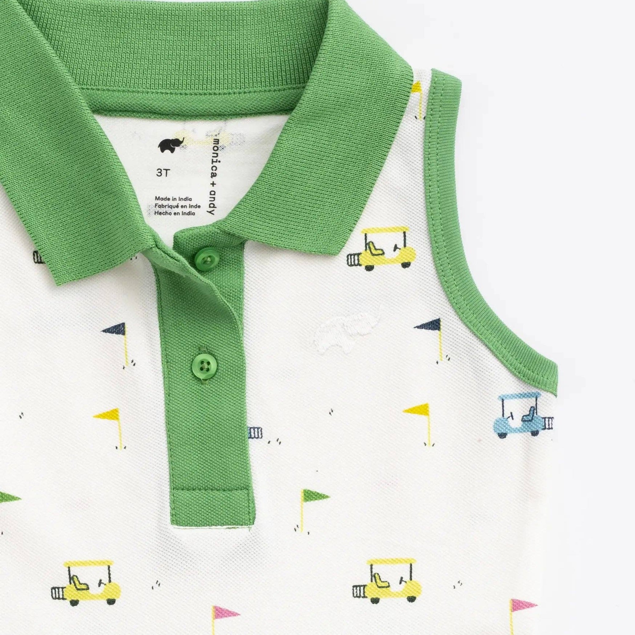 Baby girl dress with green collar and white shirt with colorful golf carts and golf flags on a white background