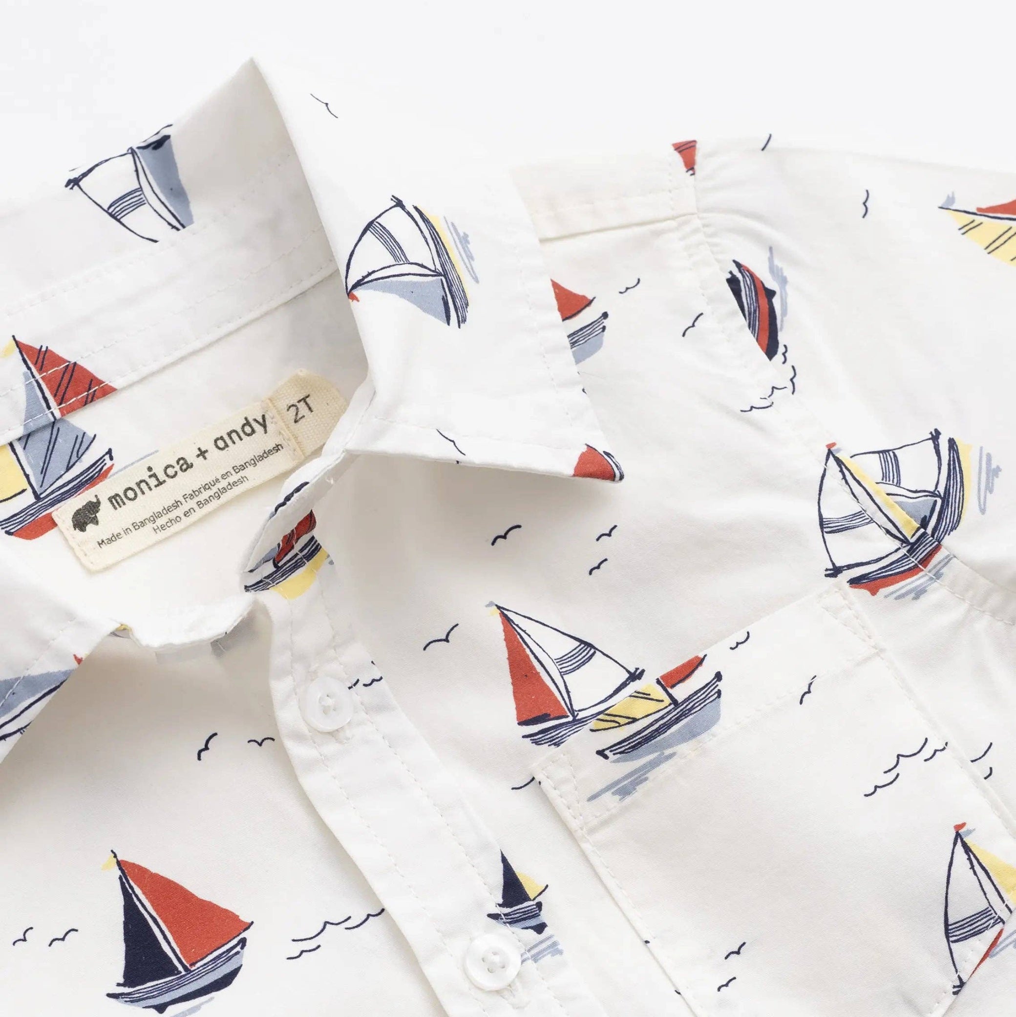 Children's shirts with sailboat pattern on a white background