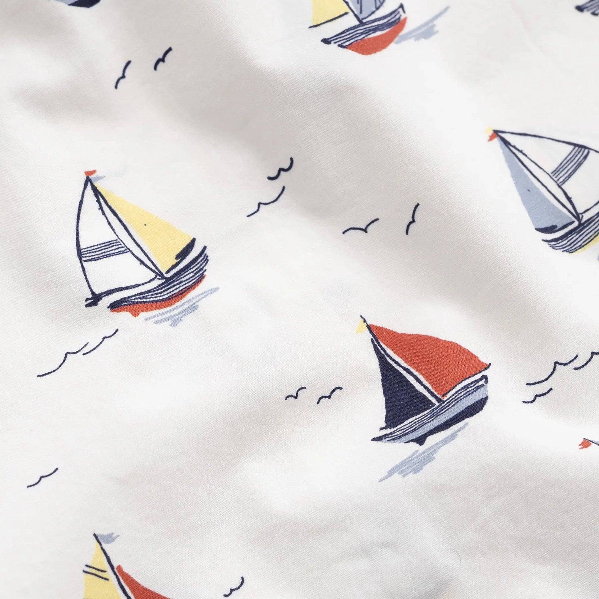 Pattern of colorful sailboats on a white background