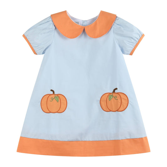 A baby girl's short-sleeve dress in light blue with an orange Peter Pan collar, orange sleeve trim, an orange hem, and two embroidered orange pumpkins on the front.