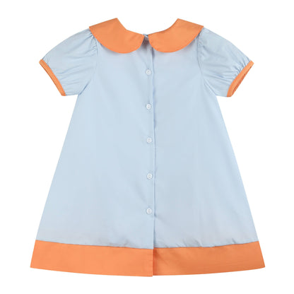 Light blue dress with orange collar and hem on a white background