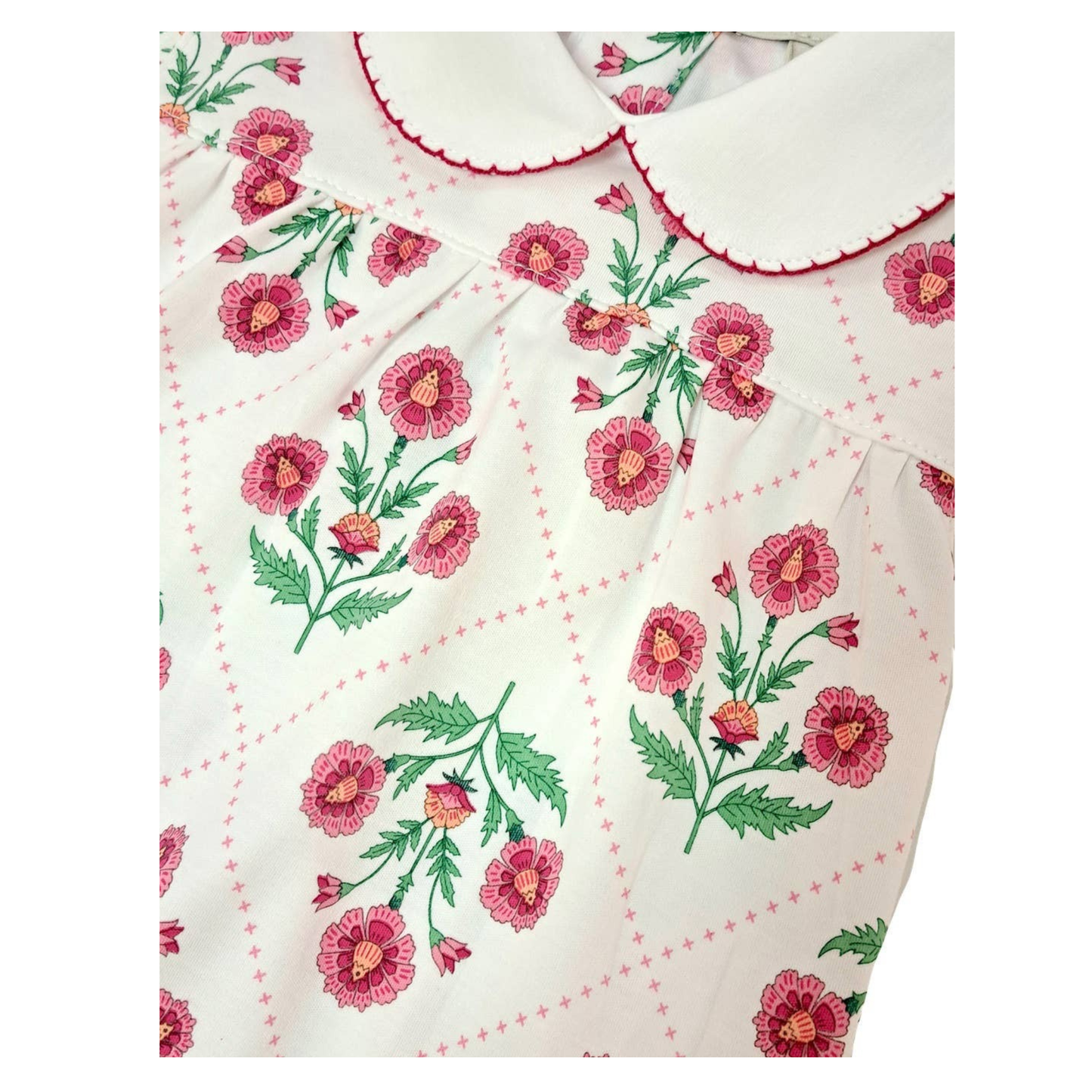 Floral patterned fabric with pink flowers and green leaves on a white background
