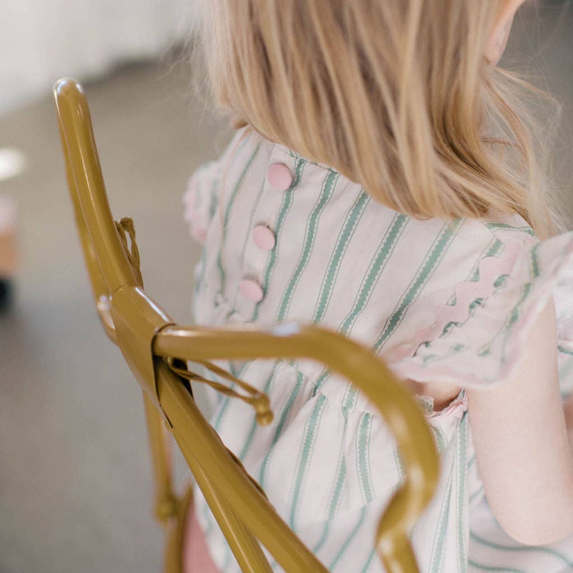 Person wearing a striped dress with a blurred background