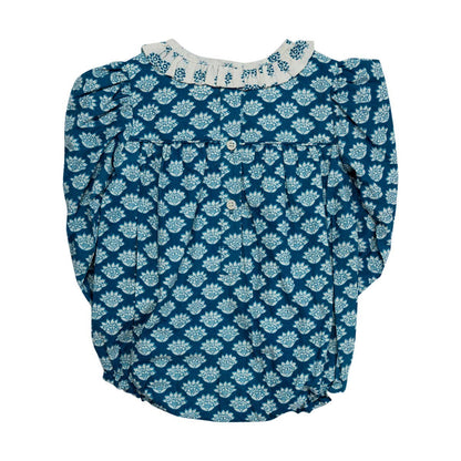 Blue floral patterned blouse with white collar on a white background