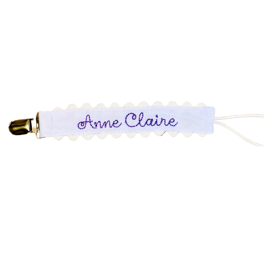 Lavender Paci Clip with White Scallop Detail on a white background