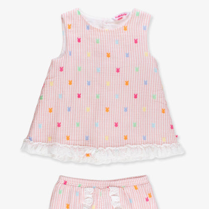 Pink children's outfit with colorful pattern on a white background