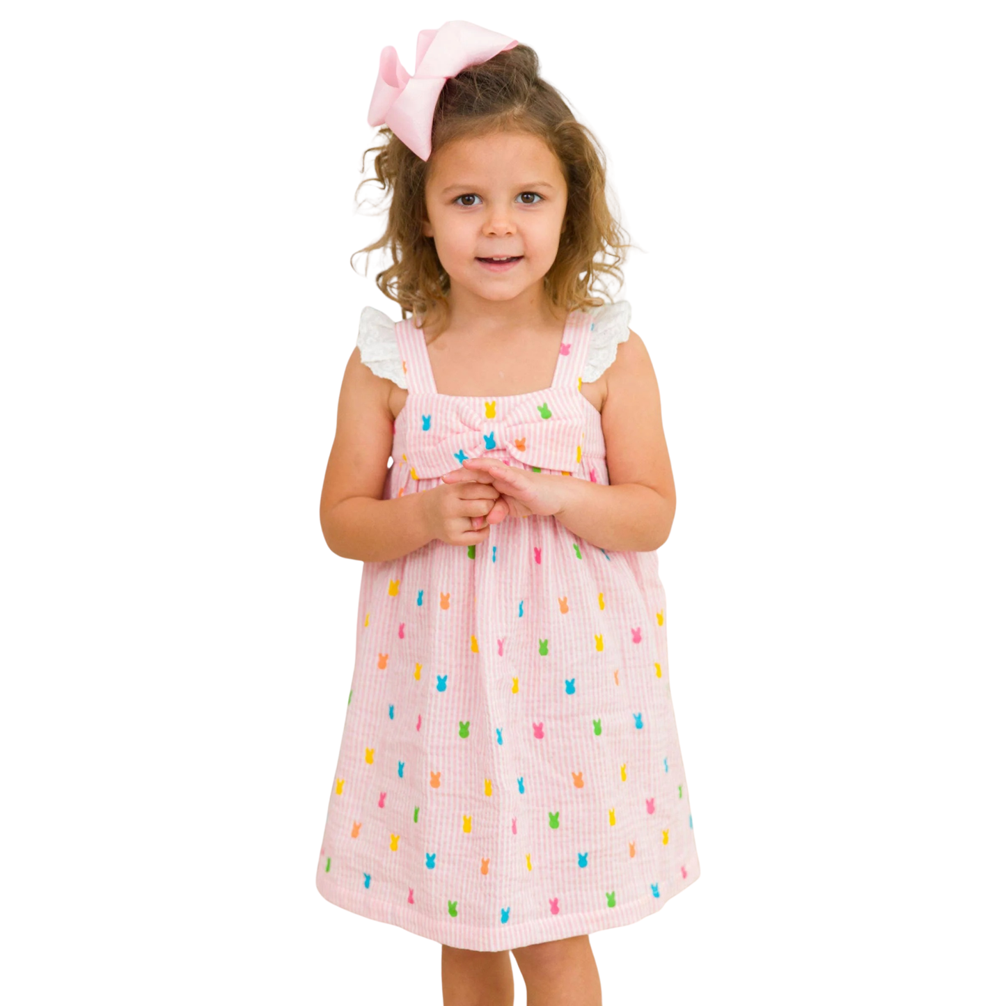 Young girl wearing a pink dress with colorful patterns on a white background