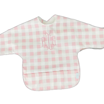 Pink and white checkered bib with embroidered initials on a white background