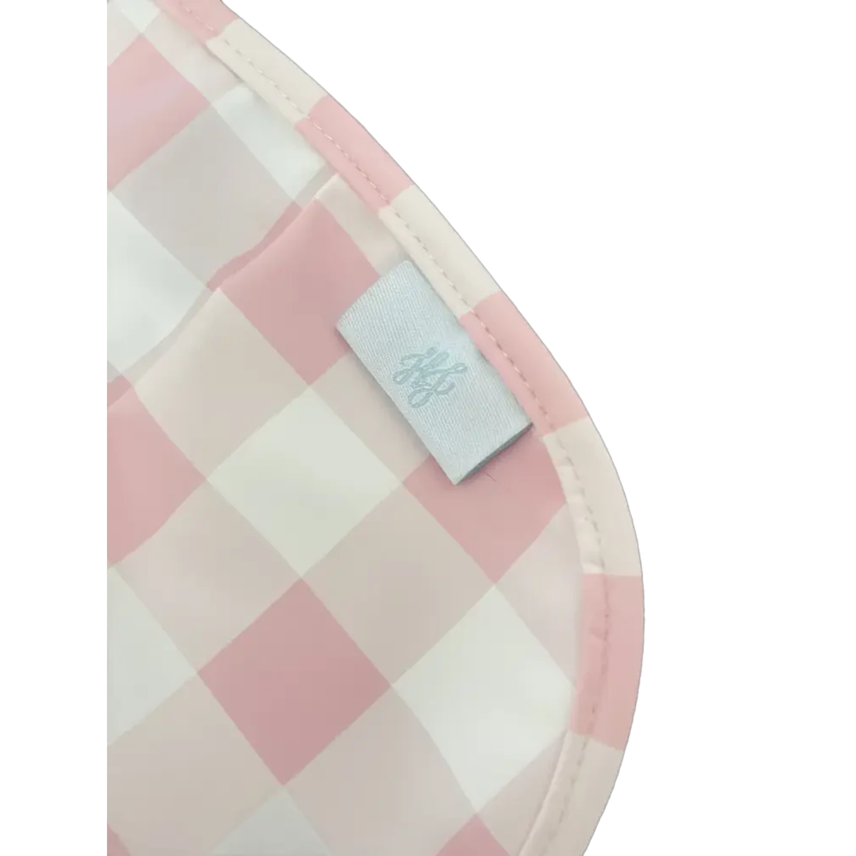 Pink and white checkered pot holder with a brand tag on a white background