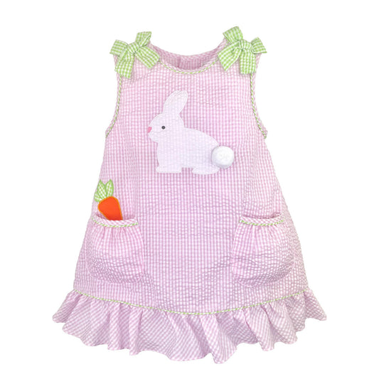 Pink seersucker dress with bunny and carrot design on a white background