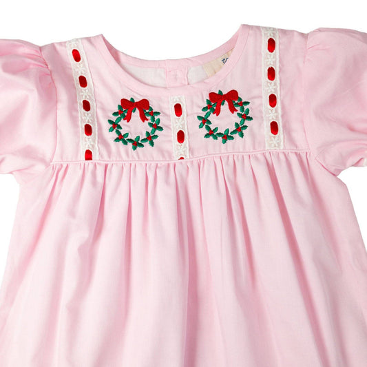 Pink dress with Christmas wreath embroidery on a white background