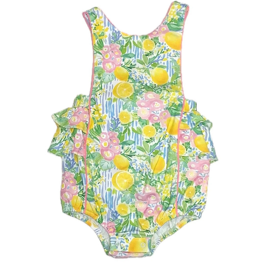 Children's sunsuit with floral and lemon pattern on a white background
