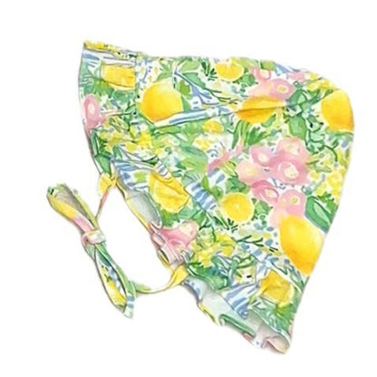 Floral and lemon-patterned swim hat on a white background