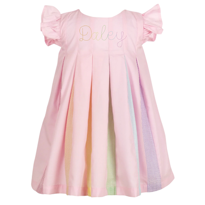 Pink dress with rainbow stripes and embroidered name on a white background