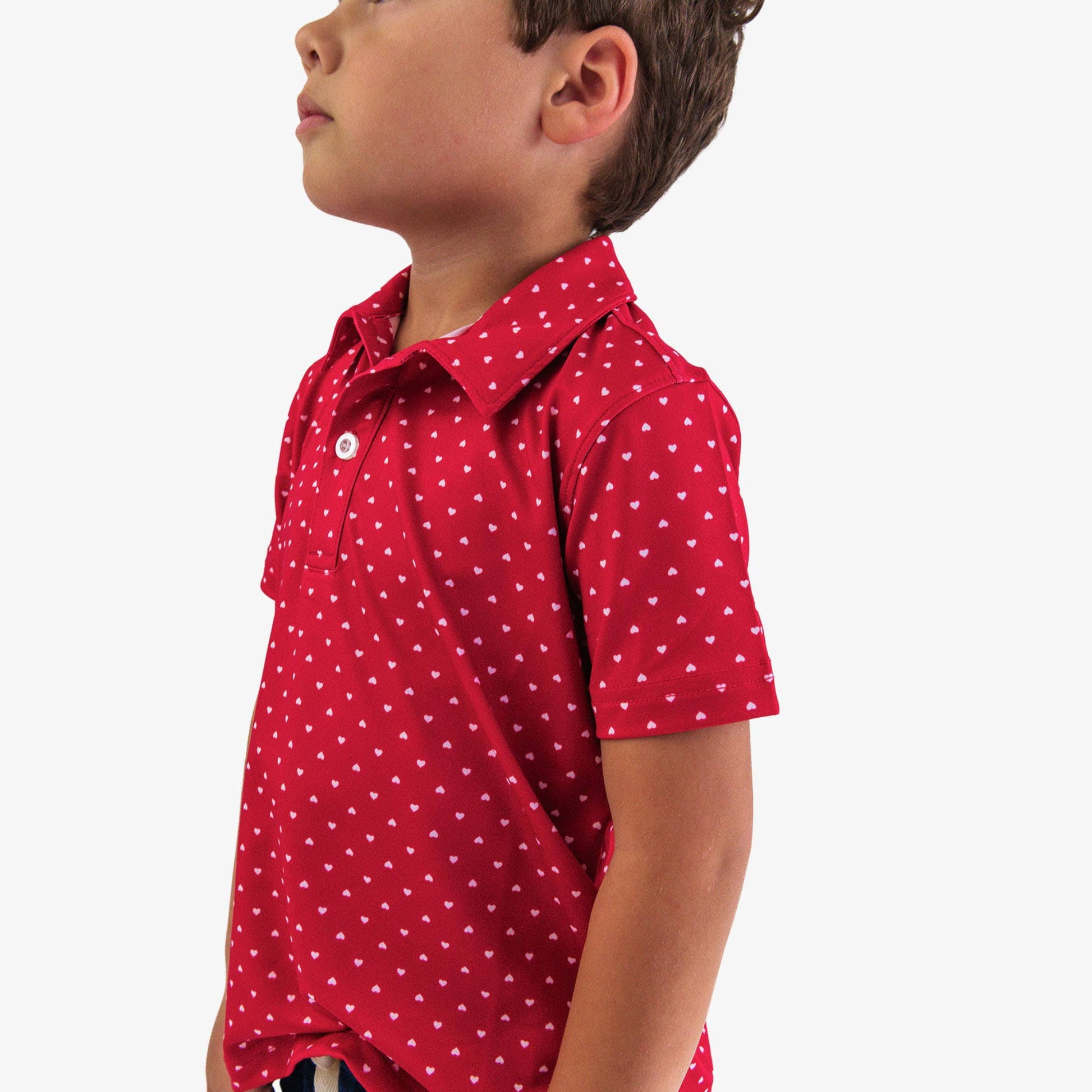 Child wearing a red polka dot shirt on a white background