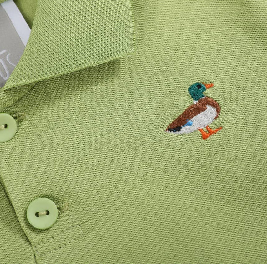 Green polo shirt with a duck embroidery detail and 'LIL CACTUS label