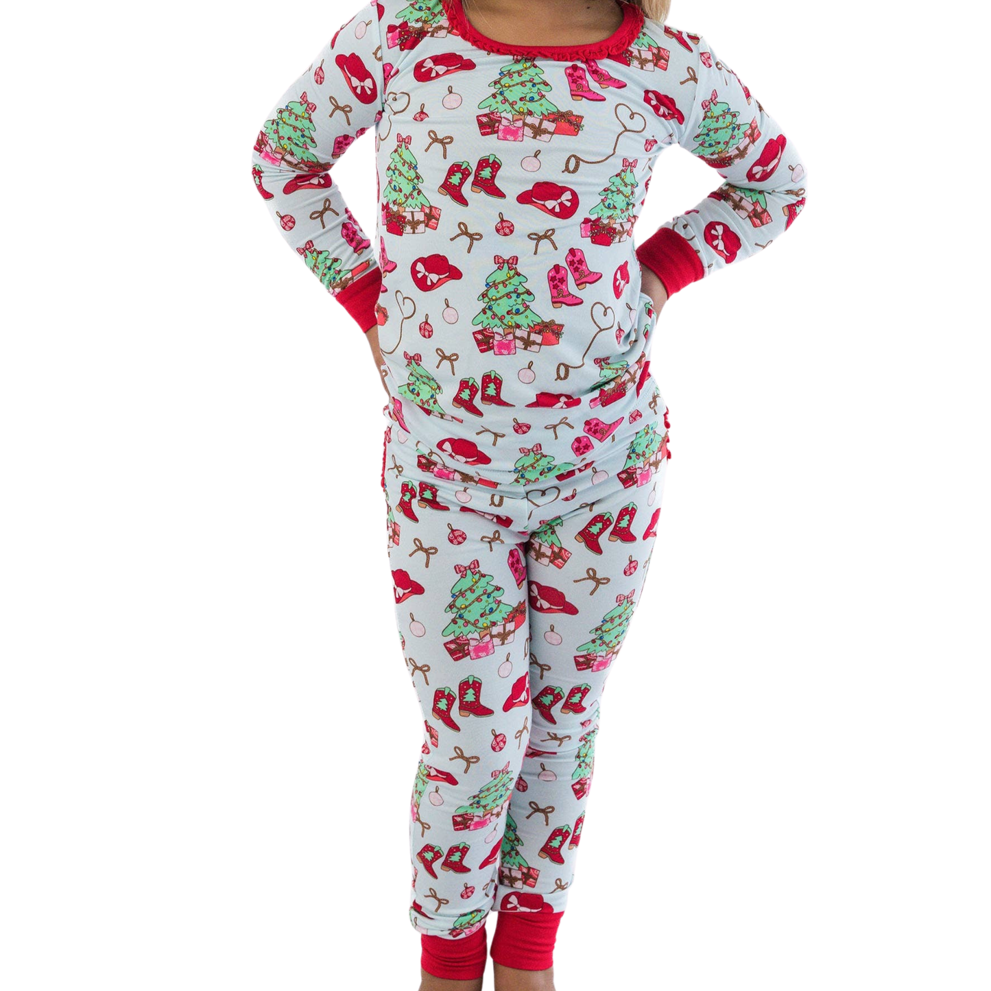 Children's cowboy Christmas-themed pajama set with red and green patterns on a white background