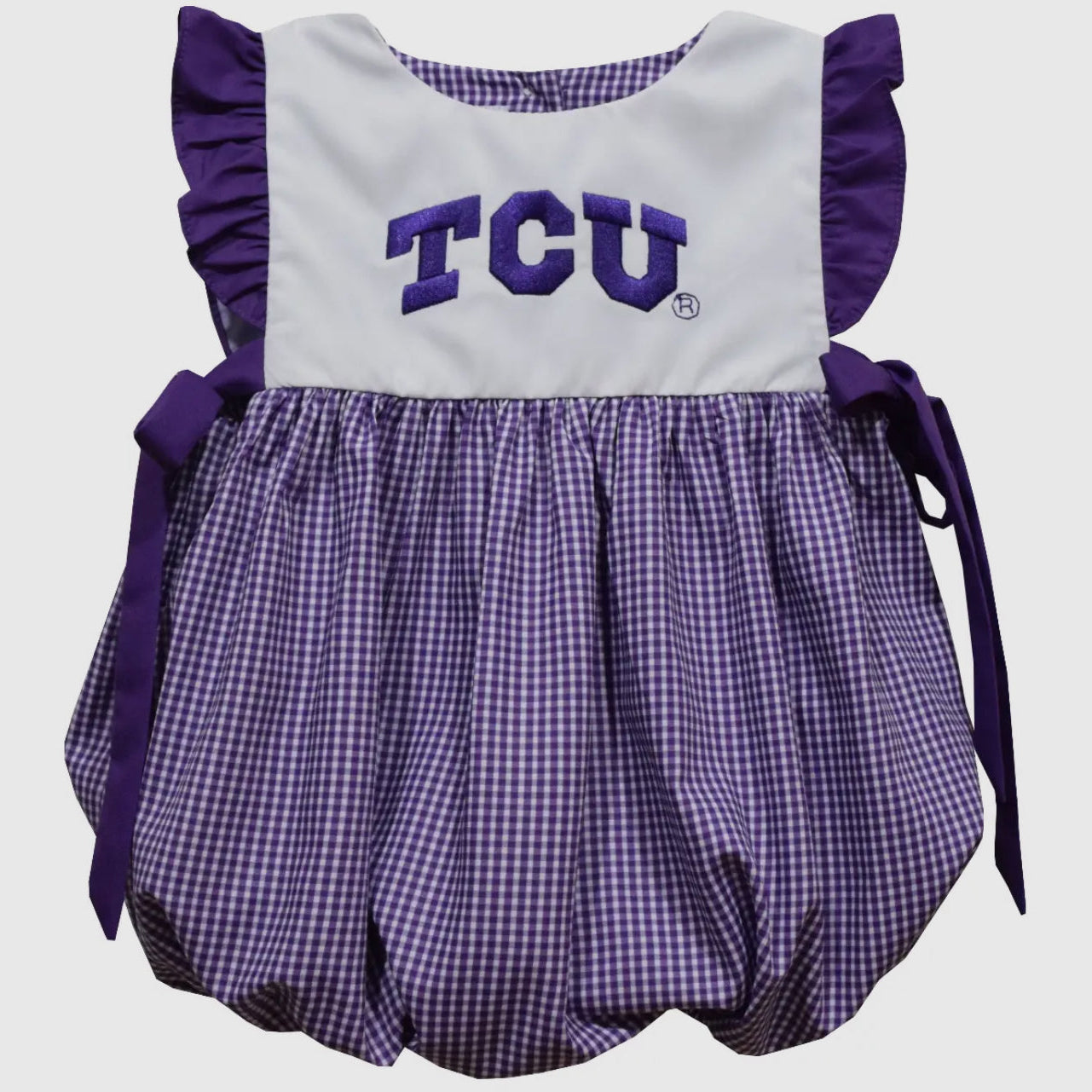 Purple and white baby romper with 'TCU' text on a light gray background